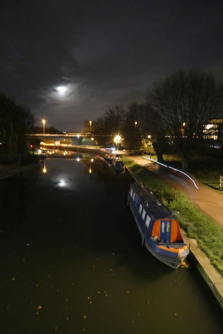 Bike lights leave a trail by the river Cam