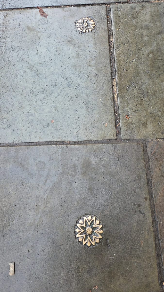 Brass flowers set into the paving