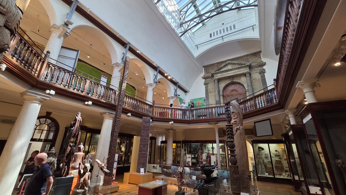 The galleried Maudslay Hall, carved poles rising through both floors